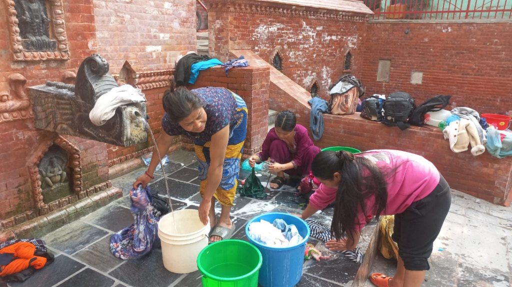 Women at a collective washing spot in Kathmandu, Nepal. doing the laundry by hand