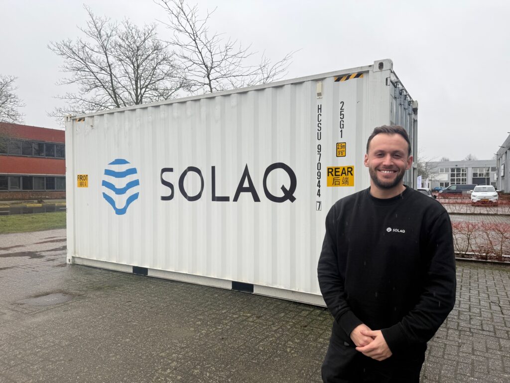 Man next to container with machinery with which his company Solaq makes water from thin air